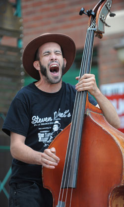 The bass player for Johnny and the Apple Stompers enjoys the moment during a performance in Acorn Alley, during the 2012 Kent State Folk Festival.