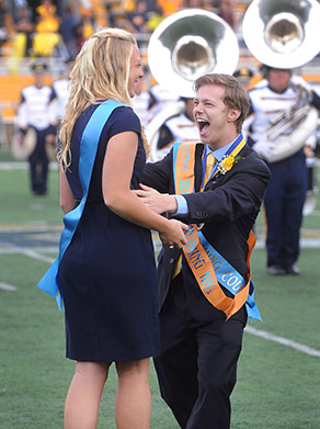 The 2013 Homecoming King and Queen celebrate as their names are announced during halftime of the football game at Dix Stadium.