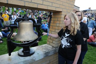 A Kent State University student and member of the May 4 Task Force rings the Victory Bell on the Commons during the 40th commemoration of the May 4, 1970, shootings at Kent State.