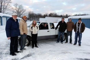 Don Coates (left), associate professor at Kent State University’s College of Technology, and some of his students prepare to take the Ford truck they converted to electric power on a test drive.