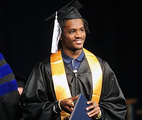 Kent State football star Dri Archer walks across the stage after receiving his diploma during the Dec. 14 morning Commencement ceremony. 