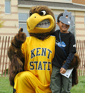 The little brother of a Kent State student poses with Flash, the university’s mascot,  during 2012 Lil’ Sibs Weekend.