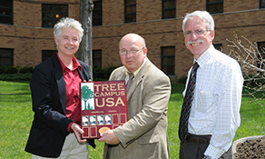 Kent State’s Grounds Manager Heather White, Senior Vice President for Finance and Administration Gregg Floyd and Associate Vice President for Facilities Planning and Operations Tom Euclide accept Kent State’s designation as an official Tree Campus USA during an Arbor Day tree-planting ceremony beside Engleman Hall.